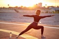 Sporty fit caucasian woman doing ashtanga vinyasa yoga asana virabhadrasana 1 warrior pose outdoors Royalty Free Stock Photo