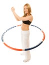 Sporty fit girl doing exercise with hula hoop. Royalty Free Stock Photo