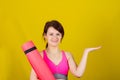 Sporty fit healthy smiling beautiful woman, red head girl holding an yoga mat Royalty Free Stock Photo