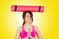 Sporty fit healthy smiling beautiful woman, red head girl holding an yoga mat on her head Royalty Free Stock Photo