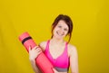 Sporty fit healthy smiling beautiful woman, red head girl holding an yoga mat Royalty Free Stock Photo