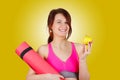 Sporty fit healthy smiling beautiful woman, red head girl holding an yoga mat Royalty Free Stock Photo