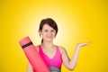 Sporty fit healthy smiling beautiful woman, red head girl holds an yoga mat Royalty Free Stock Photo