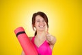 Sporty fit healthy smiling beautiful woman, red head girl holds an yoga mat Royalty Free Stock Photo
