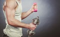 Sporty fit man lifting light and heavy dumbbells. Royalty Free Stock Photo