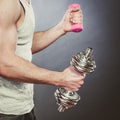 Sporty fit man lifting light and heavy dumbbells. Royalty Free Stock Photo