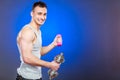 Sporty fit man lifting light and heavy dumbbells. Royalty Free Stock Photo