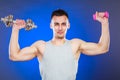 Sporty fit man lifting light and heavy dumbbells. Royalty Free Stock Photo