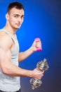 Sporty fit man lifting light and heavy dumbbells. Royalty Free Stock Photo