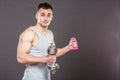 Sporty fit man lifting light and heavy dumbbells. Royalty Free Stock Photo