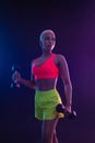 Sporty fit woman, athlete with dumbbells make fitness exercises on black background. Download cover for music collection