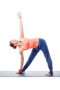 Sporty fit woman practices yoga asana utthita trikonasana