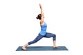 Sporty fit woman practices yoga asana utthita Virabhadras Royalty Free Stock Photo