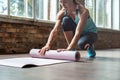 Sporty fit woman yoga instructor wear sportswear roll unroll yoga mat in gym. Royalty Free Stock Photo