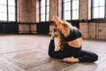 Sporty fit yogini woman doing yoga asana Eka pada kapotasana - one-legged pigeon pose in loft style class