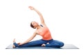 Sporty fit yogini woman practices yoga asana parivrtta janu sirs Royalty Free Stock Photo