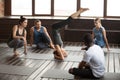 Woman standing on head practicing yoga at group training class Royalty Free Stock Photo