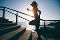 Female runner running up on seaside stairs Royalty Free Stock Photo