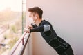 Sporty fitness man in face mask exercising push ups at home Royalty Free Stock Photo