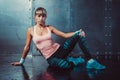 Sporty fitness woman sitting and relaxing on floor