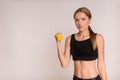 Sporty girl doing exercise with dumbbells and looking at camera Royalty Free Stock Photo