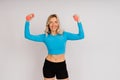 Sporty girl doing exercise with dumbbells, silhouette studio shot over dark and whitebackground Royalty Free Stock Photo