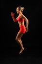 Sporty girl doing exercise with dumbbells, silhouette studio shot over dark and whitebackground Royalty Free Stock Photo