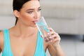 Sporty Girl Drinking Glass Of Water Sitting At Home Royalty Free Stock Photo