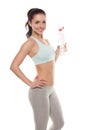 Sporty girl drinking water from a bottle after a workout, fitness training, isolated on white background Royalty Free Stock Photo