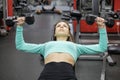 girl lying on bench does exercises with dumbbells Royalty Free Stock Photo