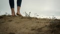 Sporty girl going hill edge closeup. Woman legs walking hilltop cloudy day. Royalty Free Stock Photo