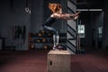 Sporty girl jumping over some boxes in a cross-training gym Royalty Free Stock Photo