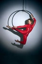 Sporty girl posing with aerial hoop