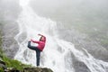 Sporty girl posing under waterfall Balea in Fagarash mountains Royalty Free Stock Photo