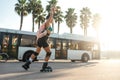 A sporty girl on roller skates against the background of the city in the sunset light on a summer day Royalty Free Stock Photo