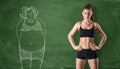 Sporty girl with slim body and picture of fat woman drawn at green chalkboard background Royalty Free Stock Photo