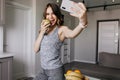 Sporty girl taking picture of herself and smiling. Indoor photo of inspired lady eating apple and m