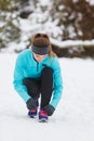 Sporty girl tying shoes. Royalty Free Stock Photo