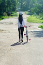 Sporty girl walks with a bicycle. plan back. Pretty fitness girl with sport bike walks in the park. Portrait of a young fitness