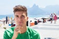 Sporty guy in a green shirt at beach at Brazil