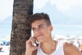 Sporty guy listening at phone at Ipanema beach at Rio de Janeiro Royalty Free Stock Photo