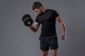 Sporty guy performing biceps curl with dumbbell Royalty Free Stock Photo