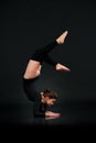 Sporty gymnastics woman on black background stretching doing Han