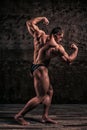 Sporty and healthy muscular man on dark grunge background Royalty Free Stock Photo