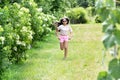 Sporty young girl running in a garden on the lawn Royalty Free Stock Photo