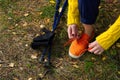 Sporty hiking woman tying shoelaces on her jogging shoes while taking a break after hiking in autumn forest. hiking concept, Royalty Free Stock Photo