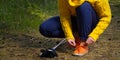 Sporty hiking woman tying shoelaces on her jogging shoes while taking a break after hiking in autumn forest. hiking concept, Royalty Free Stock Photo