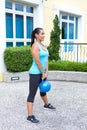 sporty hispanic woman in blue training with kettlebell doing dead lift Royalty Free Stock Photo