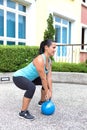 sporty hispanic woman in blue training with kettlebell doing dead lift Royalty Free Stock Photo