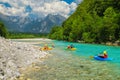 Sporty kayakers on the clean turquoise Soca river, Bovec, Slovenia